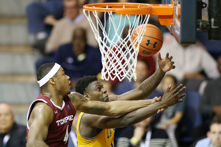 Temple forward J.P. Moorman II (left) and La Salle guard Saul Phiri fight for the ball.