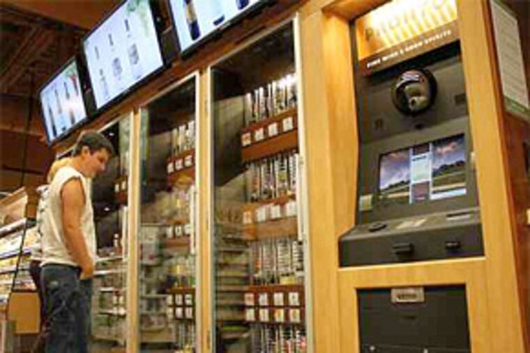 Jim Seibert and Kortney Zerphy ponder the wine selection at a Wegmans in Mechanicsburg. The dispensing area is equipped with a breath analyzer. (Evan Trowbridge / Staff)