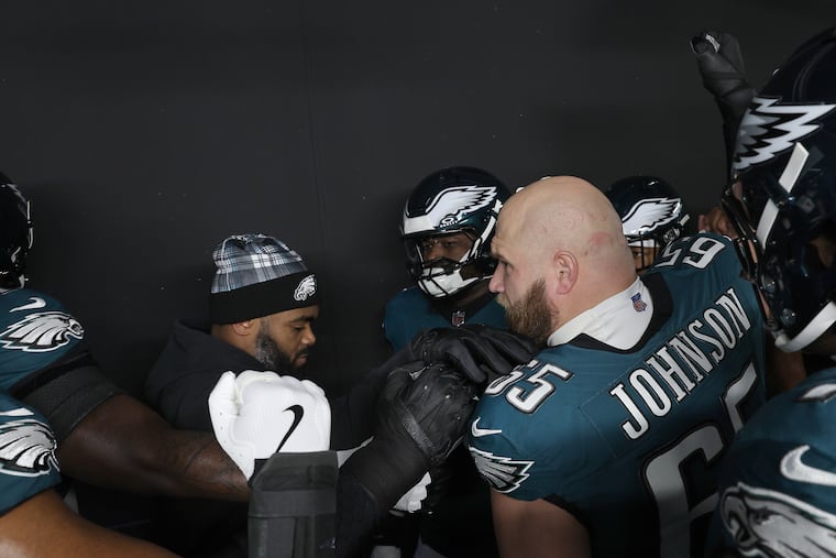 Eagles' Lane Johnson talks with his teammates in the tunnel before facing the Green Bay Packers in NFL wild-card playoff game on Jan. 12.