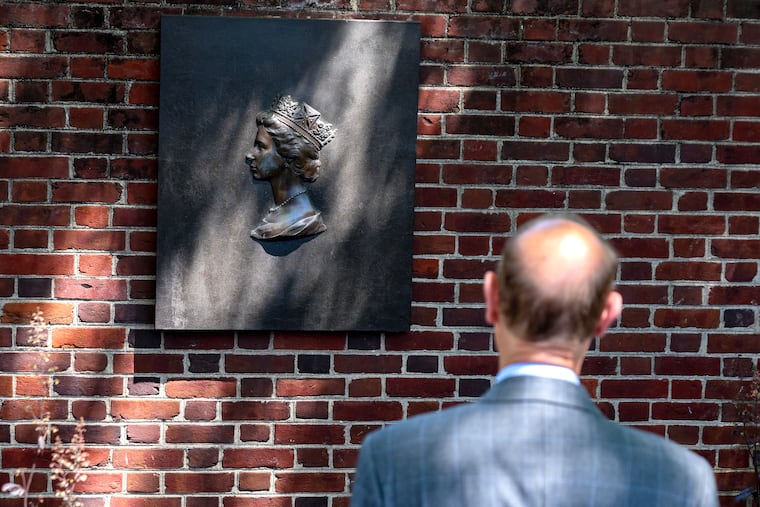 Prince Edward pauses after laying a bouquet of flowers at the commemorative portrait of his mother, Queen Elizabeth II. She visited Philadelphia in 1976 and presented the bell to the people of the United States from the people of Great Britain.