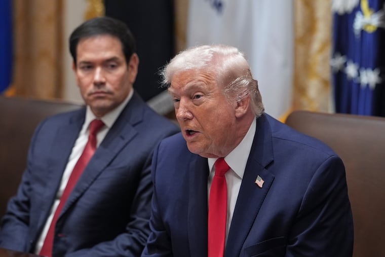 President Donald Trump speaks as Secretary of State Marco Rubio listens during Thursday's cabinet meeting at the White House.