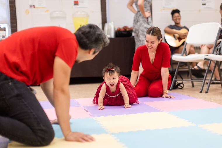 Marionne Bansing and Norly Cuyugan play with their child Keily Cuyugan during a Lullaby Project performance at Rowan University in Glassboro on Friday, June 30, 2023. The Lullaby Project is a project of Carnegie Hall, partnering with other music and social programs in the U.S. and other countries in which caregivers create lullabies for their babies, but in the process think about being caregivers and what they want for their children.