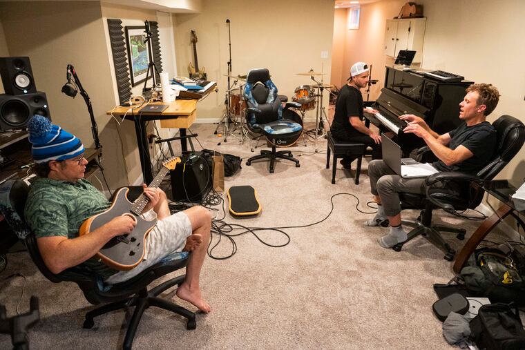 Disco Biscuits musicians Jon Gutwillig (left) and Aron Magner (center) with writer Nick Schmidle during a songwriting session at Gutwillig's home studio in Malvern.