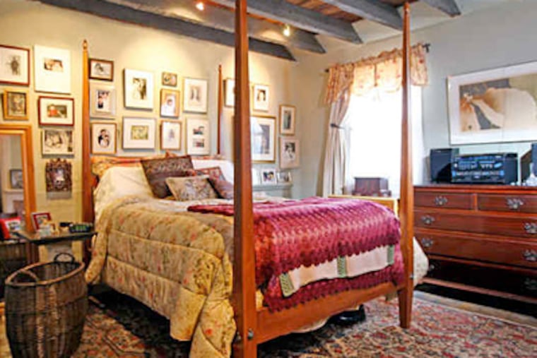 Two of the house's four fireplaces survived the rehab job, one of them in the second-floor master bedroom, which also features a beamed ceiling. The original heart-pine floors were saved on the second floor. (Michael Bryant / Staff photographer)