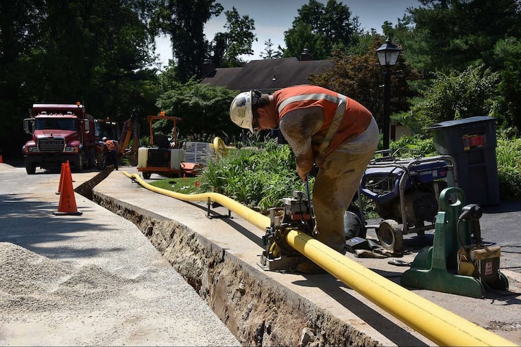 A worker installs a new gas main on Peco's system in Bryn Mawr in 2018.