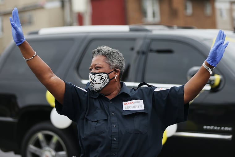 Security guard Tammy Miller (left) dances during a surprise drive-by ceremony recognizing her at the DaVita Cobbs Creek Dialysis center where she works in Southwest Philadelphia on Friday, May 29, 2020. Miller is known by patients and family members for her dancing, which helps them feel better.