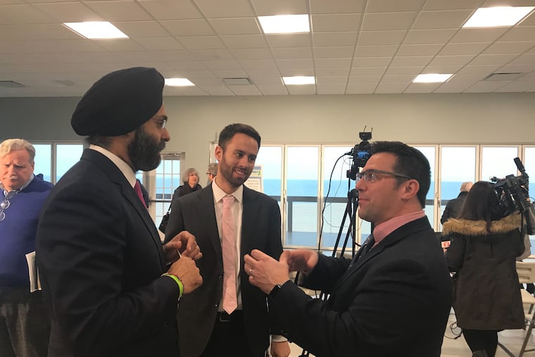 Ed Potosnak, executive director of the New Jersey League of Conservation Voters, speaks with Attorney General Gurbir Grewal and Jeremy Feigenbaum of the Attorney General's office after the announcement of several new environmental justice lawsuits.