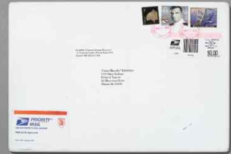 "Something of the Process," a work by Jonathan Olivares with stamps and postmarks, at the DuPont Corian Design Studio.