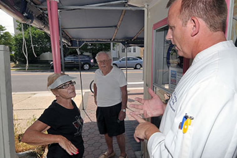 Bill McGinnity, owner of Cousin's Restaurant in Ocean City, discusses the positive aspects of BYOB on Wednesday with residents Dee Fiordaliso and Jim Gabrysz. (Gregg Kohl / For the Daily News)