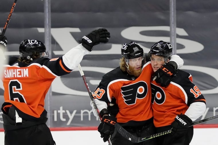 Flyers center Nolan Patrick celebrates his goal with teammates Jake Voracek (center) and Travis Sanheim on Saturday against the Washington Capitals.