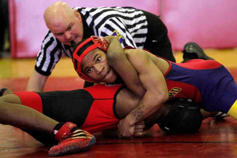 Frankford's Leonard Williams (top) tries for back points against Northeast's Andre Butts in the 112-pound bout. Butts won by pin, 33 seconds into the second period. The Vikings won, 68-3.