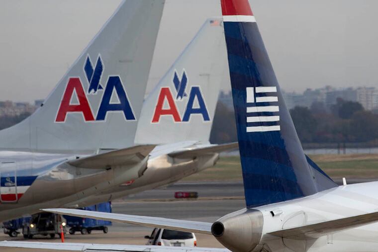 The more than 600 US Airways planes will be painted with the American Airlines colors late in 2016. (ANDREW HARRER / Bloomberg, File)