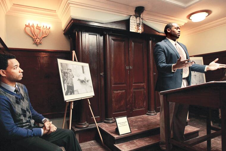 Actor Dax Richardson, left, listens as Sam Davis, right, who is a 1st year doctoral student at Temple University, speaks about Dr. Martin Luther King, Jr. during an event at Eastern State Penitentiary in Philadelphia, Pa. on January 19, 2014. Richardson read parts of Dr. King's Letter From Birmingham Jail. ( DAVID MAIALETTI / Staff Photographer )
