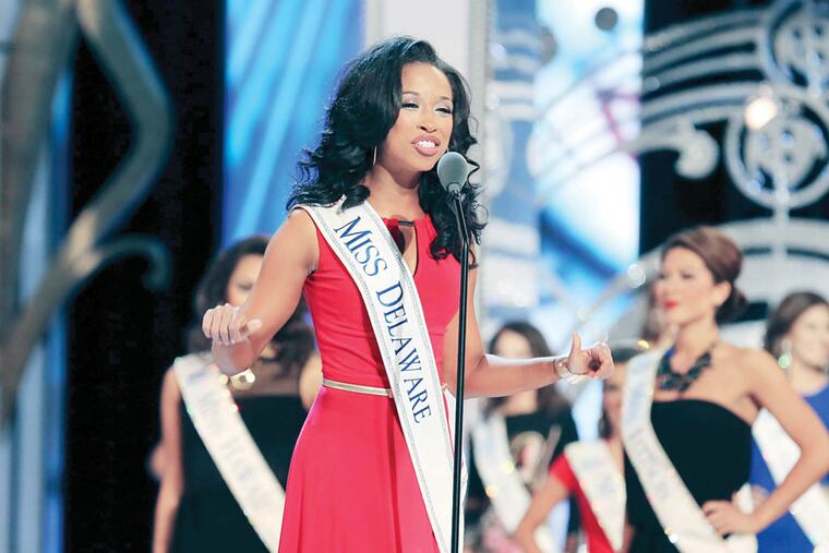 Miss Delaware Brittany Lewis introduces herself during the parade of states at the first night of preliminary competition at the Miss America competition at Boardwalk Hall, in Atlantic City, N.J., Tuesday, Sept 9, 2014. (AP Photo/The Press of Atlantic City, Edward Lea)