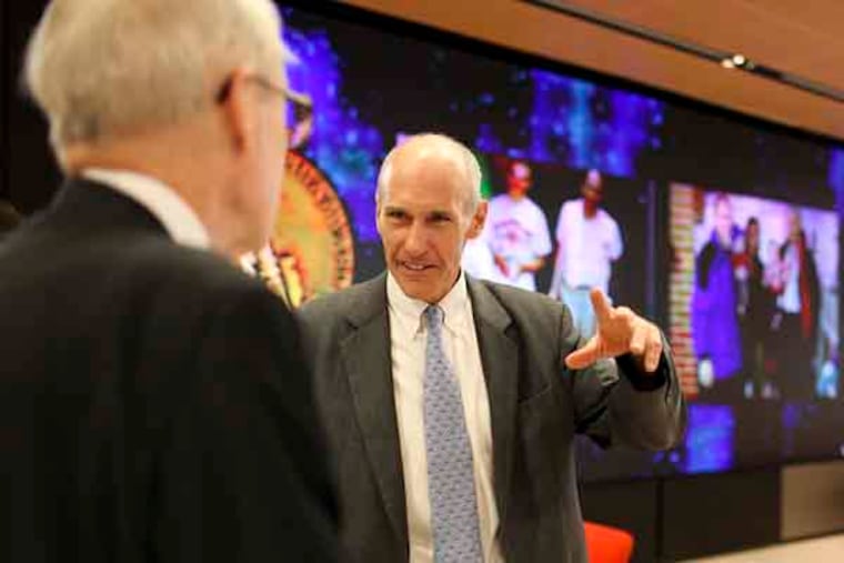Dr. Carl June speaks with members of the board of the Phildelphia Award before the ceremony on May 31, 2013. Dr. June is this year's recipient of the award for his research on cancer. Staff photo by Andrew Renneisen