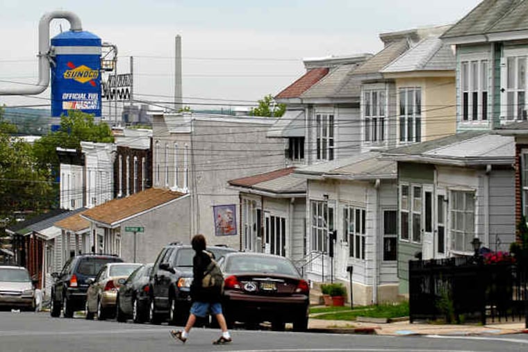 A student walks to Linwood Elementary School the morning after an overnight explosion at the Sunoco Marcus Hook refinery.