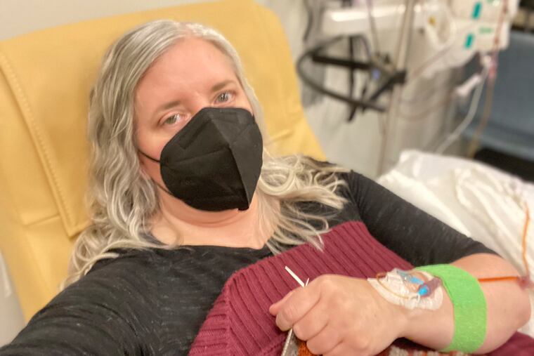 Amy Watson of Portland, Ore., shows her during an iron infusion. Watson, approaching 50, says she has “never had any kind of recovery” from COVID-19. She has had severe migraines, plus digestive, nerve and foot problems. Recently she developed severe anemia.