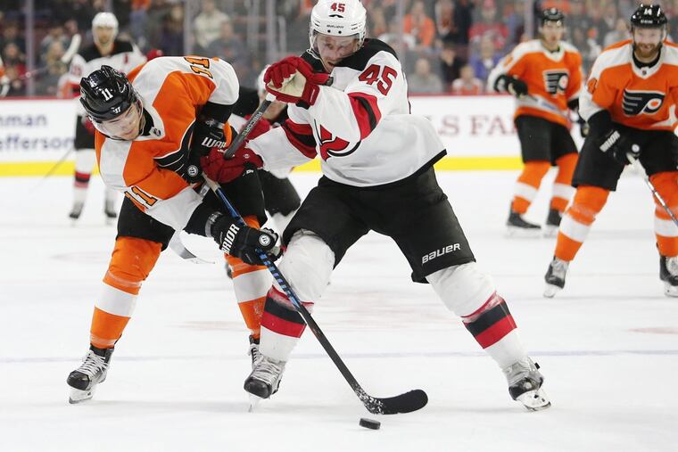 Winger Travis Konecny skating after the puck against Devils defenseman Sami Vatanen in the Flyers’ 3-1 win on Jan. 20.