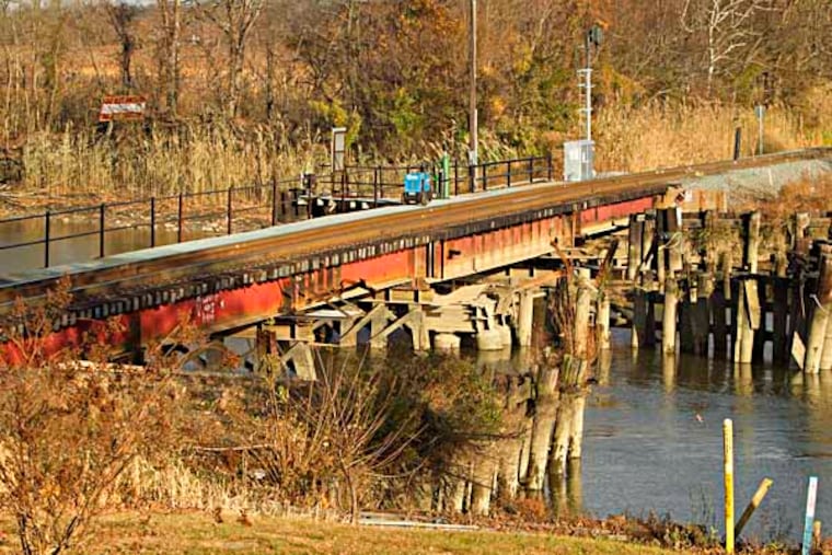 Andrew Seidman writes about Paulsboro, NJ, one year after a horrific train derailment there. Here the railroad bridge over the MAntua Creek, site of the 2012 derailment. ( ED HILLE / Staff Photographer )