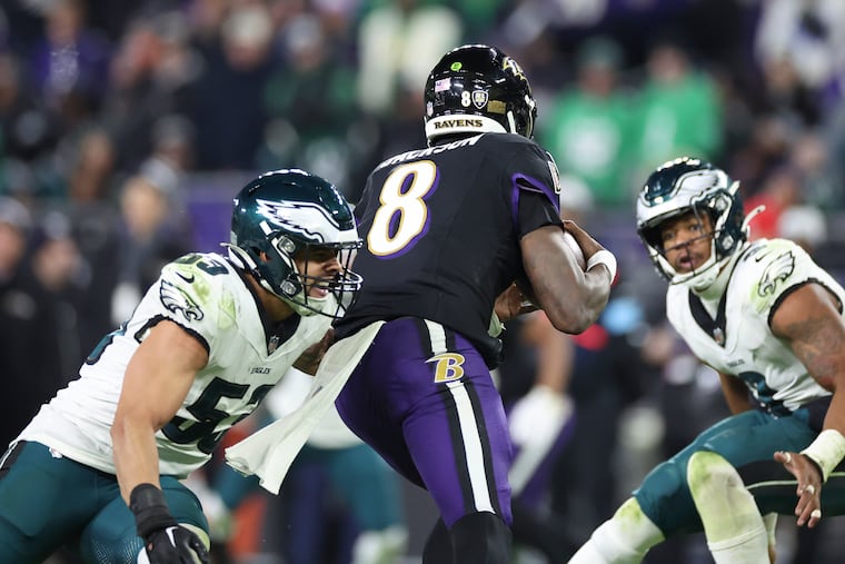Eagles linebacker Zack Baun (53) closes in on Ravens quarterback Lamar Jackson in the third quarter Sunday as Nolan Smith looks on.