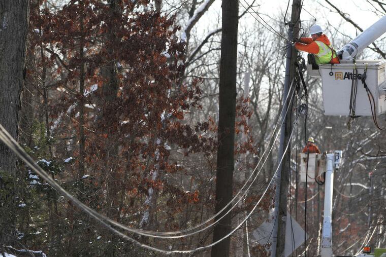 On Waynesborough Road in Paoli, lineman Jim O'Hara from Foley Electric of Brick, N.J., replaces a transformer. Crews are continuing to work through the cold nights, some pulling 16-hour shifts, Peco said.