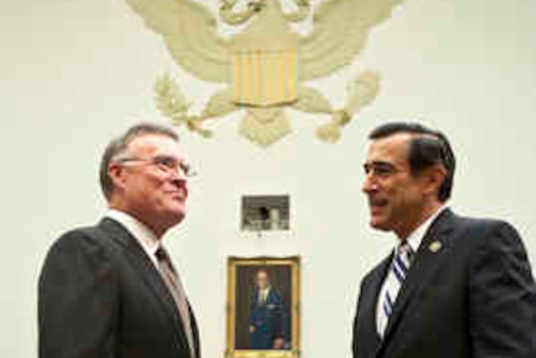 Kenneth D. Lewis (left), CEO of Bank of America, speaks with Rep. Darrell Issa (R., Calif.), before testifying to the House Committee on Oversight and Government Reform. Lewis said yesterday that he proceeded with the Merrill deal because of pressure from regulators.