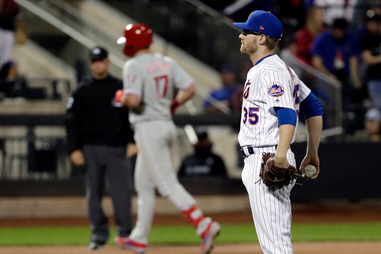 Jacob Rhame watches as Rhys Hoskins runs the bases following a two-run homer on Wednesday.