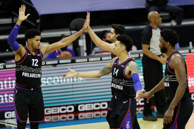 Sixers forward Danny Green celebrated with teammates forward Tobias Harris, guard Furkan Korkmaz, and center Joel Embiid during a game against the shorthanded Brooklyn Nets on Feb. 6.