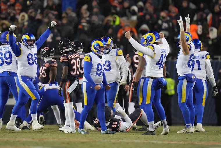 Los Angeles Rams kicker Harrison Mevis, center, reacts with holder Ethan Evans, center right, and teammates after booting a game-winning field goal during overtime of an NFL football divisional playoff game Sunday, Jan. 18, 2026, in Chicago. (AP Photo/Jeff Roberson)