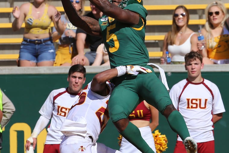 To the delight of Bears fans in the background, Baylor wide receiver Denzel Mims pulls down a touchdown pass over Iowa State defensive back Anthony Johnson on Sept. 28, in Waco, Texas.