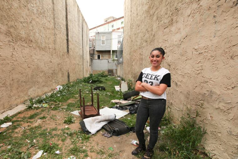 Melissa Alvarez, 15 is one of five teens from Kensington spent the summer working with mentors -- designers, architects and landscapers -- to come up with unique ideas for two forlorn lots on Kensington Avenue. Two of the ideas will be executed in an unusual community project, Thursday, October 3, 2013. (Steven M. Falk / Staff Photographer)