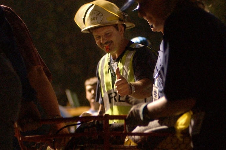 Sipesville Fire Chief Mark Zambanini gives the thumbs up sign as miner Mark Popernack, the ninth and final miner, is rescued from the Quecreek mine early on July 28.