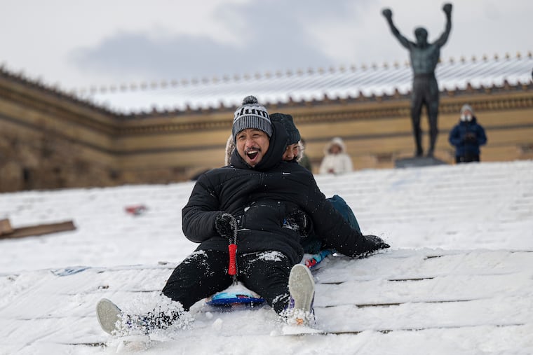 Yerome Rillera and his 9-year-old son, Kersey, sled down the steps of the Philadelphia Art Museum in January following a snowstorma.