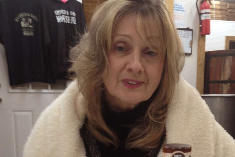 Nancy Hatfield, great-great-granddaughter of patriarch William Anderson "Devil Anse" Hatfield, with some of Hatfield & McCoy Moonshine's offerings.