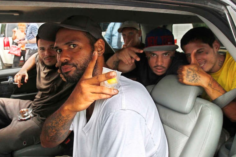 Eddie, flashing the peace sign, and four other residents of Fairhill's Tent City accept a ward leader's offer to be driven to rehab.