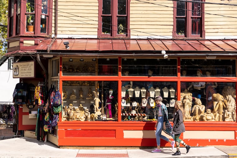Julia Levis of New Hope and friend Sydney Norris of West Philadelphia walk pass Three Cranes Gallery along Main Street in New Hope.