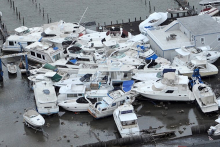 Boats jumbled together at a marina in Brant Beach, on Long Beach Island on the New Jersey Shore on Tuesday, a day after Hurricane Sandy blew across the New Jersey barrier islands. ( CLEM MURRAY / Staff Photographer )
