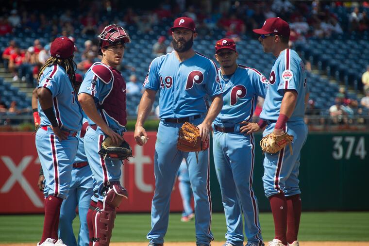 Jake Arrieta, center, and Rhys Hoskins, right, would get a career boost with a productive two months of an abbreviated baseball season.