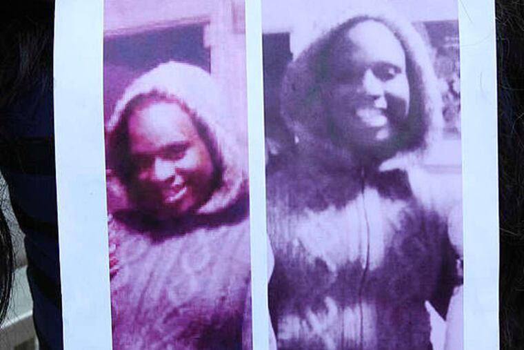 Aamina Morrison holds photos of Diamond Williams during a vigil in 2013. Williams' alleged killer was held for trial yesterday.