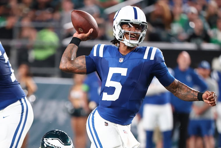 Indianapolis Colts quarterback Anthony Richardson passes the football against Eagles defensive tackle Robert Cooper (right) and Tyreek Maddox-Williams (left) in the second quarter during a preseason game on Thursday, August 24, 2023 in Philadelphia.