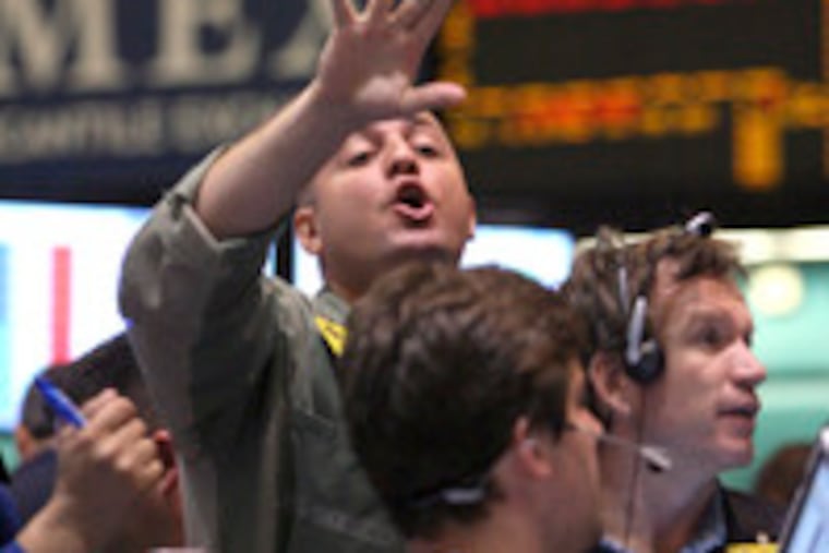Traders work the crude oil options pit at the New York Mercantile Exchange. Light, sweet crude oil for August delivery rose as high as $142.99 a barrel before closing at a record $140.21 a barrel yesterday.