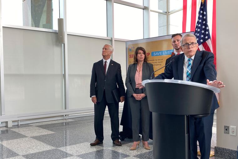 Ohio Gov. Mike DeWine discusses a law that gives school districts the option of arming trained school employees, on Monday in Columbus, Ohio.