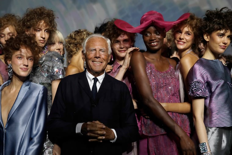 Giorgio Armani poses with models at the end of his women's 2019 Spring-Summer collection, which was unveiled during the Fashion Week in Milan, Italy, on Sept. 23, 2018.