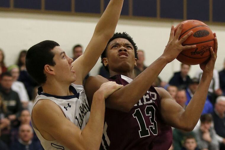 St. Joseph's Prep Ed Croswell (right) attempts to lay-up the basketball against La Salle High's Zach Crisler during the first-quarter on Friday, February 3, 2017. YONG KIM / Staff Photographer