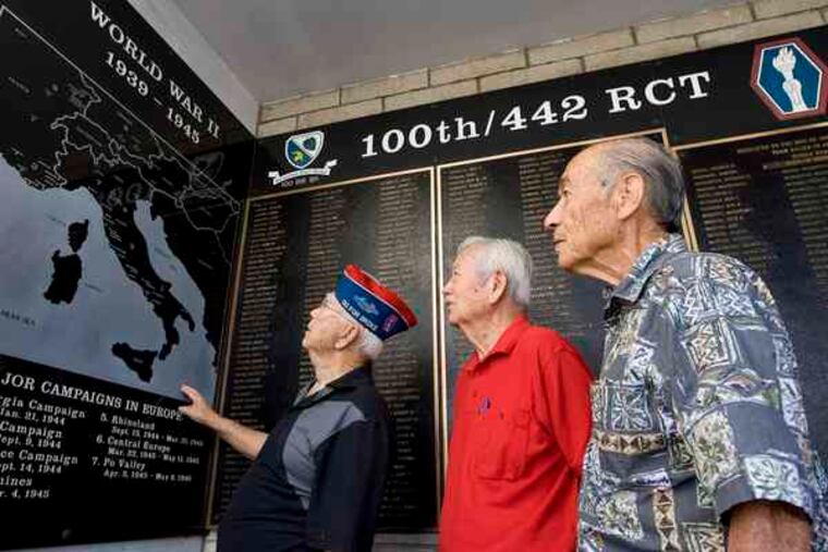 A memorial in Honolulu at the 442d Veterans Club notes the World War II campaigns of the unit, whose members included (from left) Ronald Oba, George Nakasato, and William Thompson.