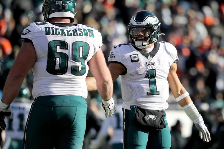 Philadelphia Eagles quarterback Jalen Hurts (right) celebrates with Landon Dickerson (left) after he scores in the third quarter as the Eagles play the Bears on Sunday, Dec. 18, 2022, in Chicago, Ill.