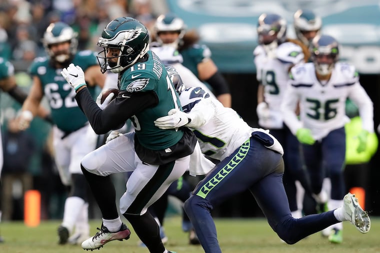 Eagles wide receiver J.J. Arcega-Whiteside runs with the football against Seattle Seahawks cornerback Tre Flowers in last week's 17-9 loss.