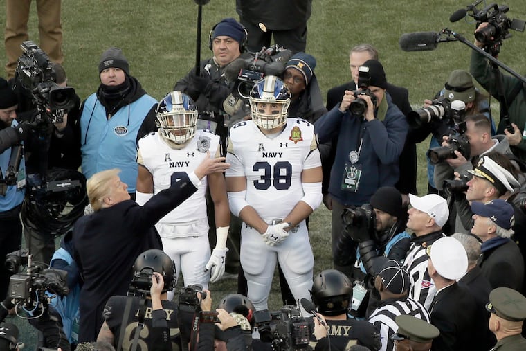 President Trump tosses the coin prior to the 119th Army vs. Navy football game at Lincoln Financial Field in Philadelphia.