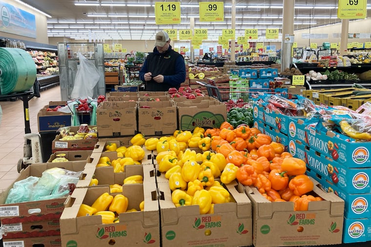 A man looks at his mobile phone while shopping at a grocery store in Buffalo Grove, Ill., in March.