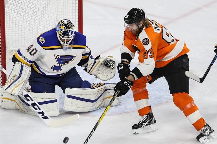 Jake Voracek tries to get to the puck in front of Blues goalie Carter Hutton during a game last season.